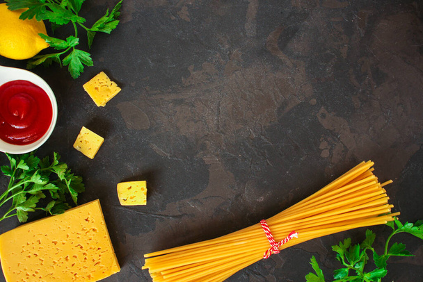 ingredients for pasta on dark stone background - Foto, Imagen