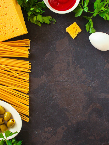 ingredients for pasta on dark stone background - Fotoğraf, Görsel