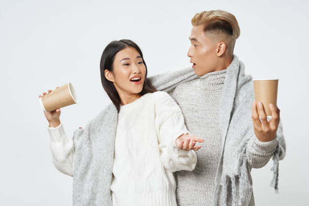 young asian couple with plaid warming drink fashion - Zdjęcie, obraz