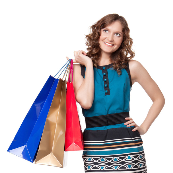 Portrait of young woman carrying shopping bags - Foto, imagen