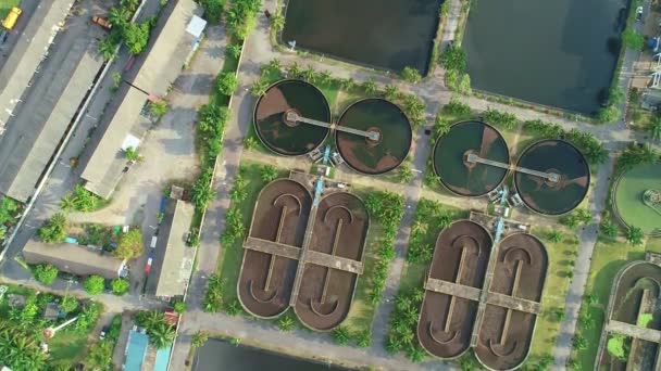 Aerial view High angle view Top down drone shot of the sewage treatment plant.The Solid contact clarifier tank type sludge recirculation in water treatment plant. Industrial wastewater treatment plant - Footage, Video