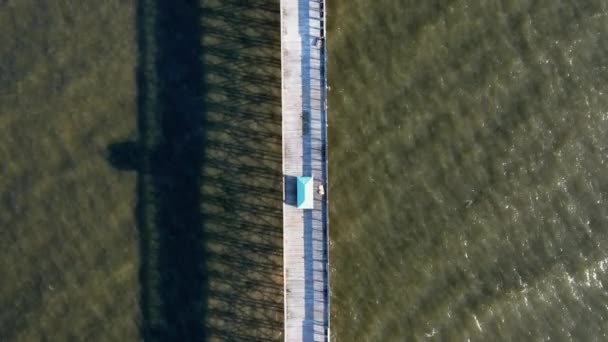 Aerial view of peaceful dock and kiosk above the calm sea - Footage, Video
