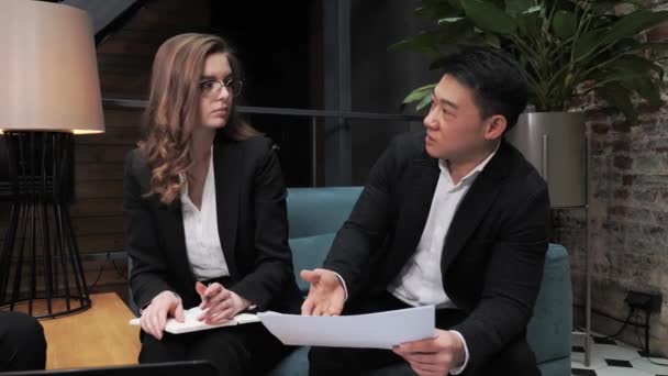Business woman company international representative having negotiation with asian male partner explaining contract details presenting commercial offer papers in modern office Business App Network. - Záběry, video