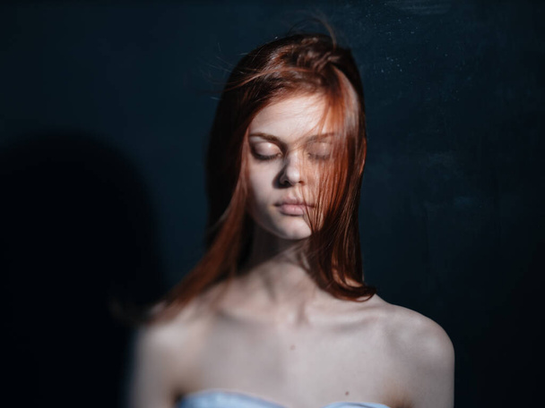 Romantic woman with red hair on a dark background model close-up portrait - Fotó, kép