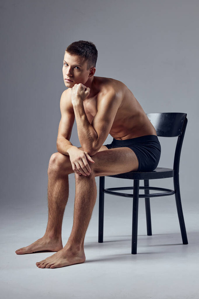 sporty man sitting on chair pensive look fitness lifestyle - Photo, Image