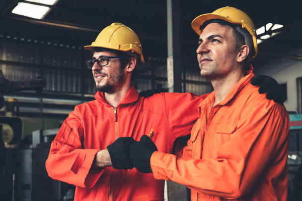 Two skillful factory engineer or worker showing teamwork and partnership . - Фото, зображення