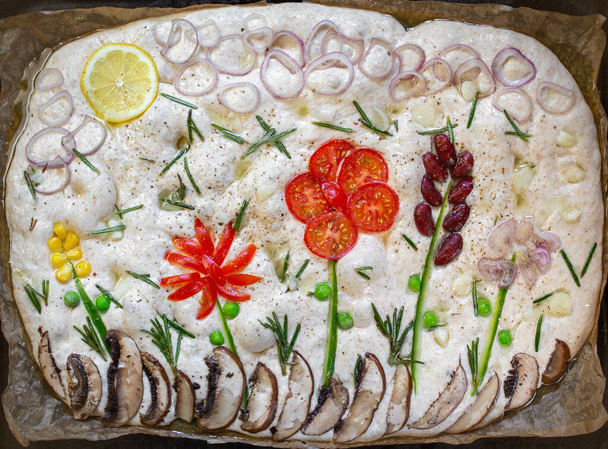 Focaccia pişiriyorum. Çiğ Focaccia, parşömen kağıdındaki sebzelerle yaratıcı bir şekilde dekore edilmiş. Ekşi hamur - Fotoğraf, Görsel