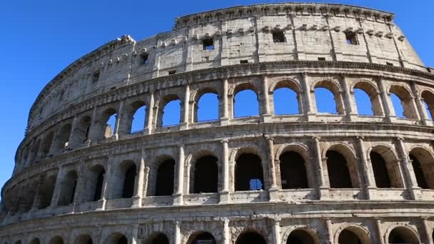 Colosseum, Rome, Italy. Roman Coliseum on summer day with blue sky. Beautiful view of the famous Italian landmark travel icon in the Roman forum. - Footage, Video