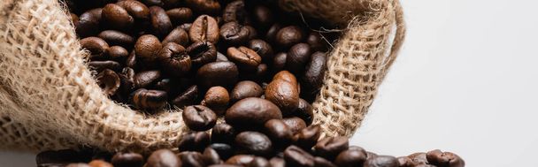 close up of hessian sack bag with roasted coffee beans isolated on white, banner - Photo, Image