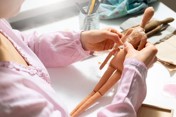 A woman master makes designer dolls from handmade fabric. - Φωτογραφία, εικόνα