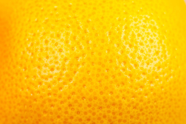 Close-up foto van Grapefruit schil textuur. Exotische rijpe fruit achtergrond, macro-view. - Foto, afbeelding