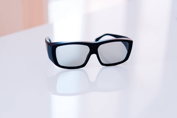 Black rimmed sunglasses on the table - Photo, Image