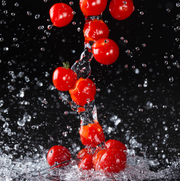 Tomatoes in water splashes - Фото, изображение