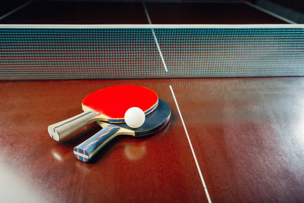 table tennis rackets and ball, net background - Photo, Image