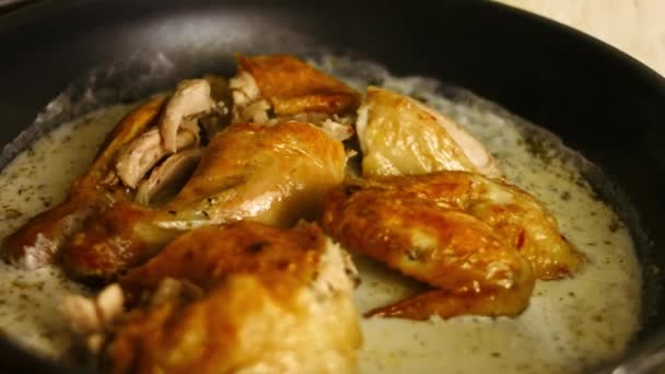 Añadir pollo asado al horno grande tallado a la salsa especiada en una sartén. Proceso de cocción shkmeruli - plato georgiano - Metraje, vídeo