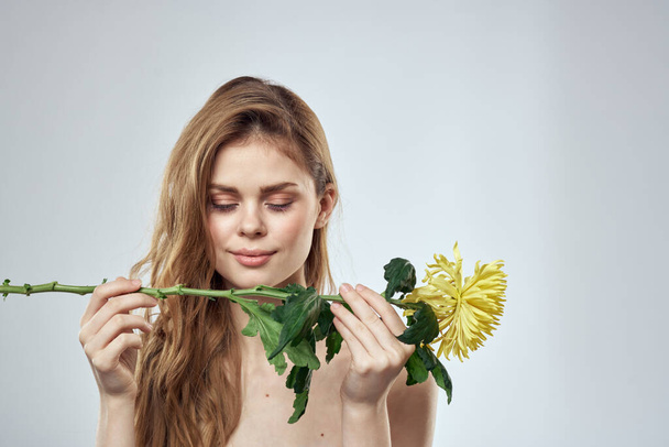 Beautiful girl with flowers cropped view portrait close-up - Foto, imagen