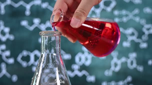 Laboratory glassware with blackboard background with various chemical formulas. - Footage, Video