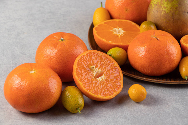 verse sinaasappels op grijze tafelondergrond - Foto, afbeelding