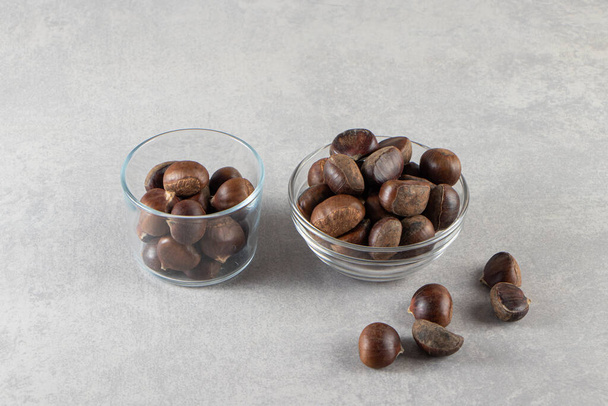 chestnuts in a bowls on a gray background - Foto, Imagen