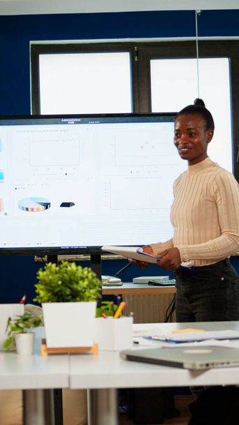 Black analyst using digital interactive whiteboard for presentation - Photo, Image
