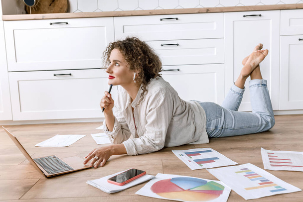 young woman with laptop on the floor at home   - Photo, image