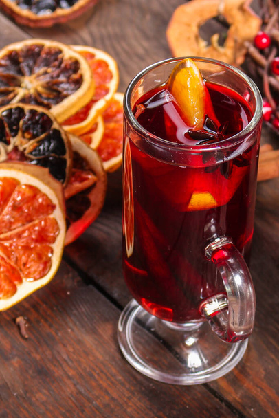 mulled wine with spices and fruits on wooden background  - Фото, зображення