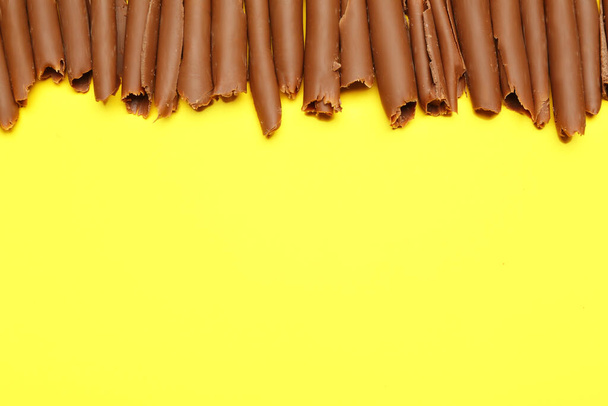 Delicious chocolate curls on color background - Photo, Image