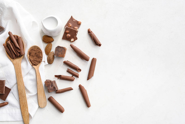 Chocolate pieces and curls on white background - Photo, Image