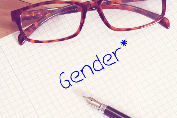 Reading glasses, exercise book and the word gender - Photo, Image