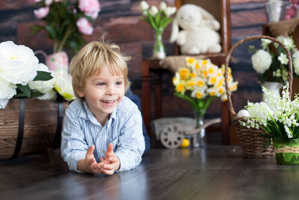 Cute toddler blond child, boy with easter decoration in studio - Фото, изображение