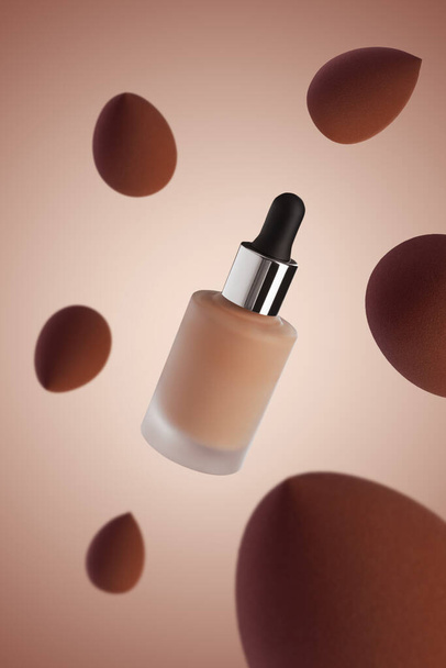 Bottle of skin foundation with makeup tool sponges flying around on brown background (flip image) - Photo, Image