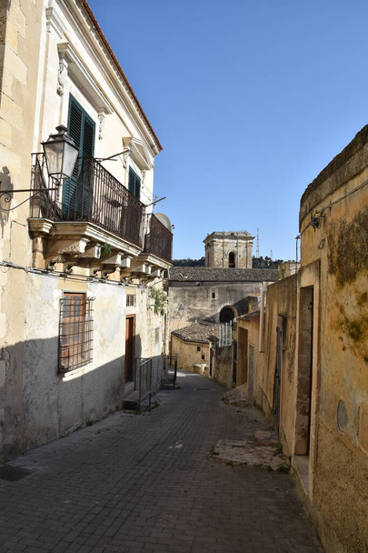 A narrow street between the houses of Modica, an old town in the region of Sicily, Italy. - Photo, Image