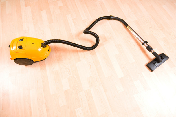 Vacuum cleaner on the polished wooden floor - Valokuva, kuva