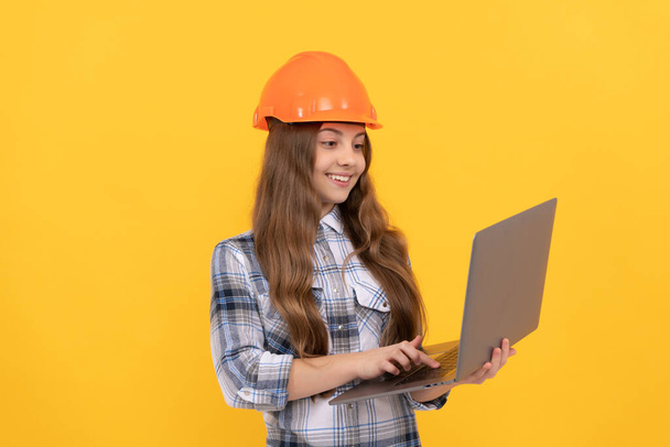 ready to work. childhood online education. happy labour day. future career. teen girl use laptop. builder kid hold computer. building and construction. webinar. happy child worker wear hardhat. - Photo, Image
