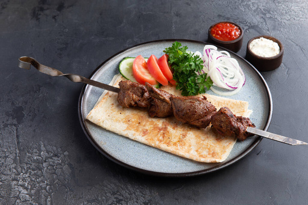 Lamb shashlik on a skewer in a plate. Selective focus - Photo, Image