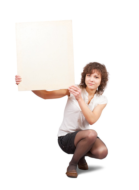 Girl holds blank canvas. It is isolated on a white background - Fotografie, Obrázek