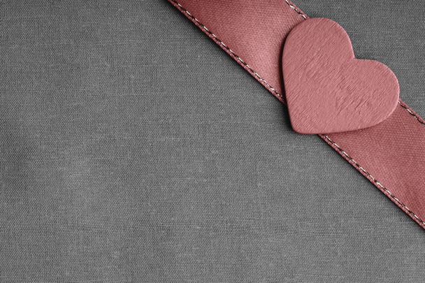 Red wooden decorative heart on grey gray cloth background. - 写真・画像