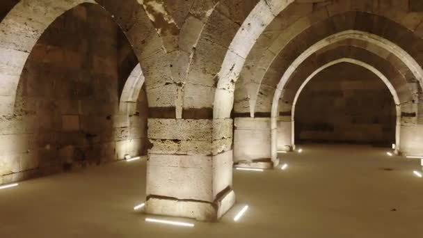 Interior of historical building with stone arches and domes.Cathedral minster church sultan Han caravanserai caravansary khan wikala funduq medieval architecture caravanserais temple chapel column columns arch niche courtyard detail ornamental mosque - Footage, Video