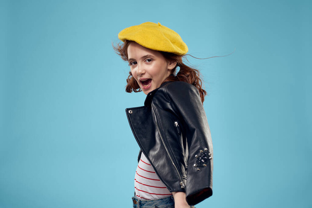 Cheerful cute girl in yellow hat clothes studio blue background - Fotoğraf, Görsel