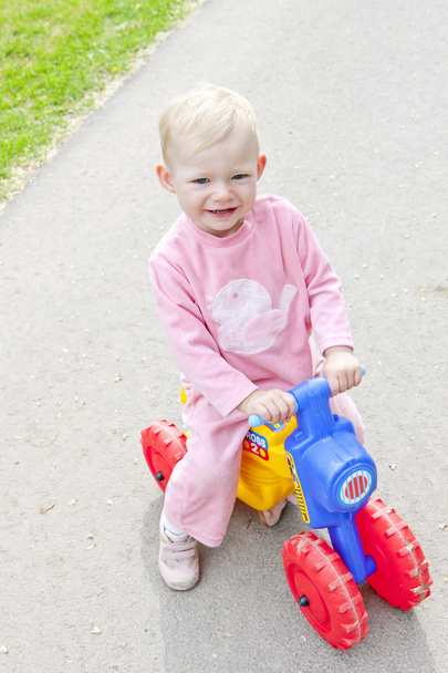 Little girl on toy motorcycle - Photo, Image