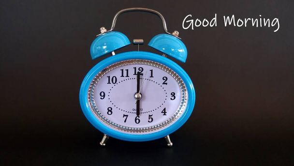 blue alarm clock against black background  - Фото, зображення