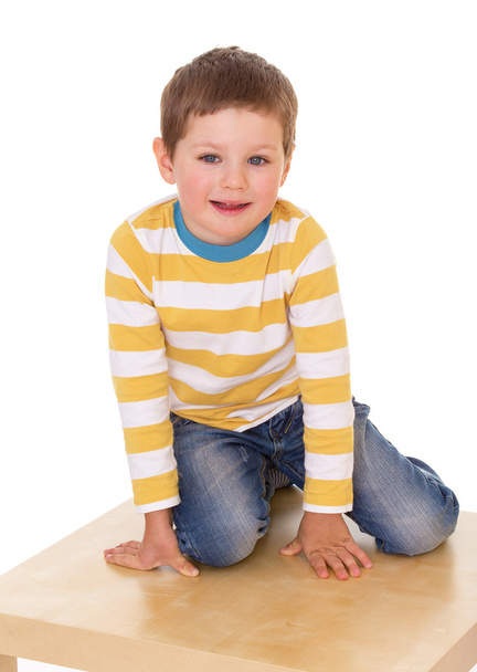 Little boy is sitting on the table. - Photo, image