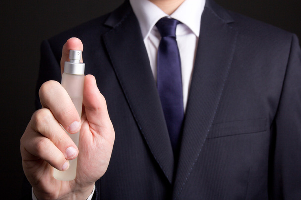 perfume bottle in business man hand - Foto, afbeelding