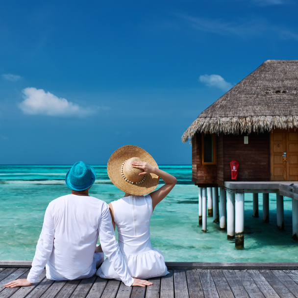 Couple on a beach jetty at Maldives - Photo, Image