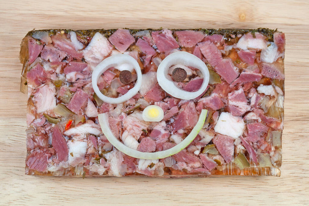 Pork head brawn  with face made from onion rings - Photo, Image