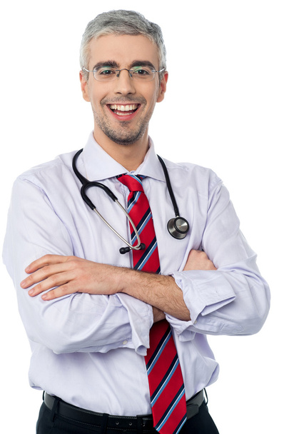 Male doctor smiling with arms crossed - Zdjęcie, obraz