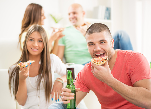Молодые люди едят пиццу
 - Фото, изображение