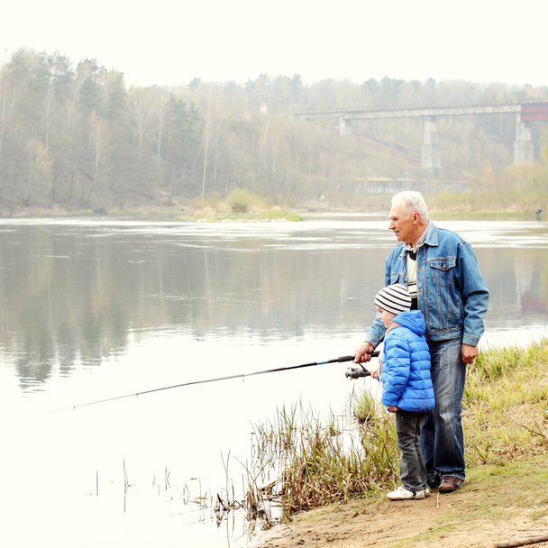 Grandfather and grandson are fishing - 写真・画像