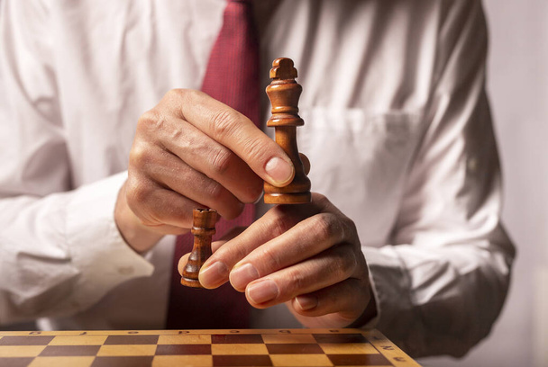 Business strategy and changing concept. Male hands removing king and rook. - Fotoğraf, Görsel