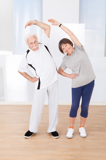 Senior Couple Doing Stretching Exercise - Foto, immagini